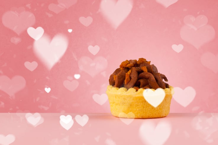 Delicious pretty party cakes with heart shape symbols on colorful background