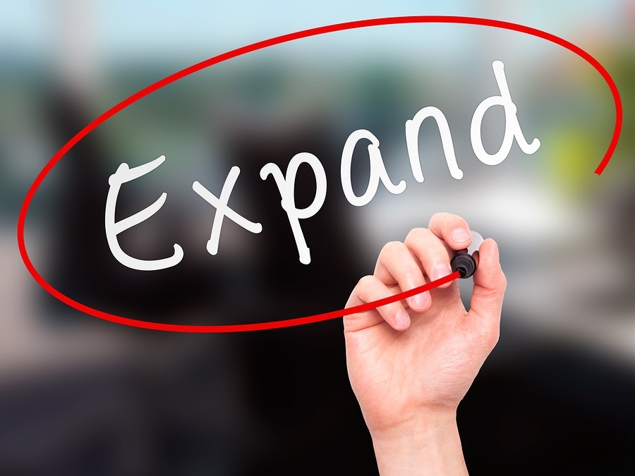 bigstock-Man-Hand-writing-Expand-with-m-91296641
